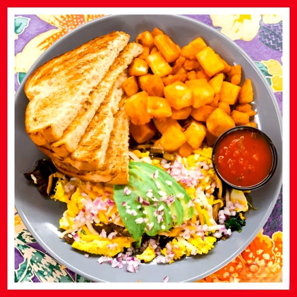 Crazy Burger's breakfast plate with scrambled eggs, avocado, toast, home fries, and salsa.